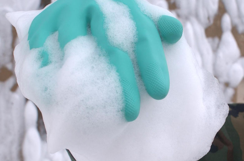 Glove with decontamination foam